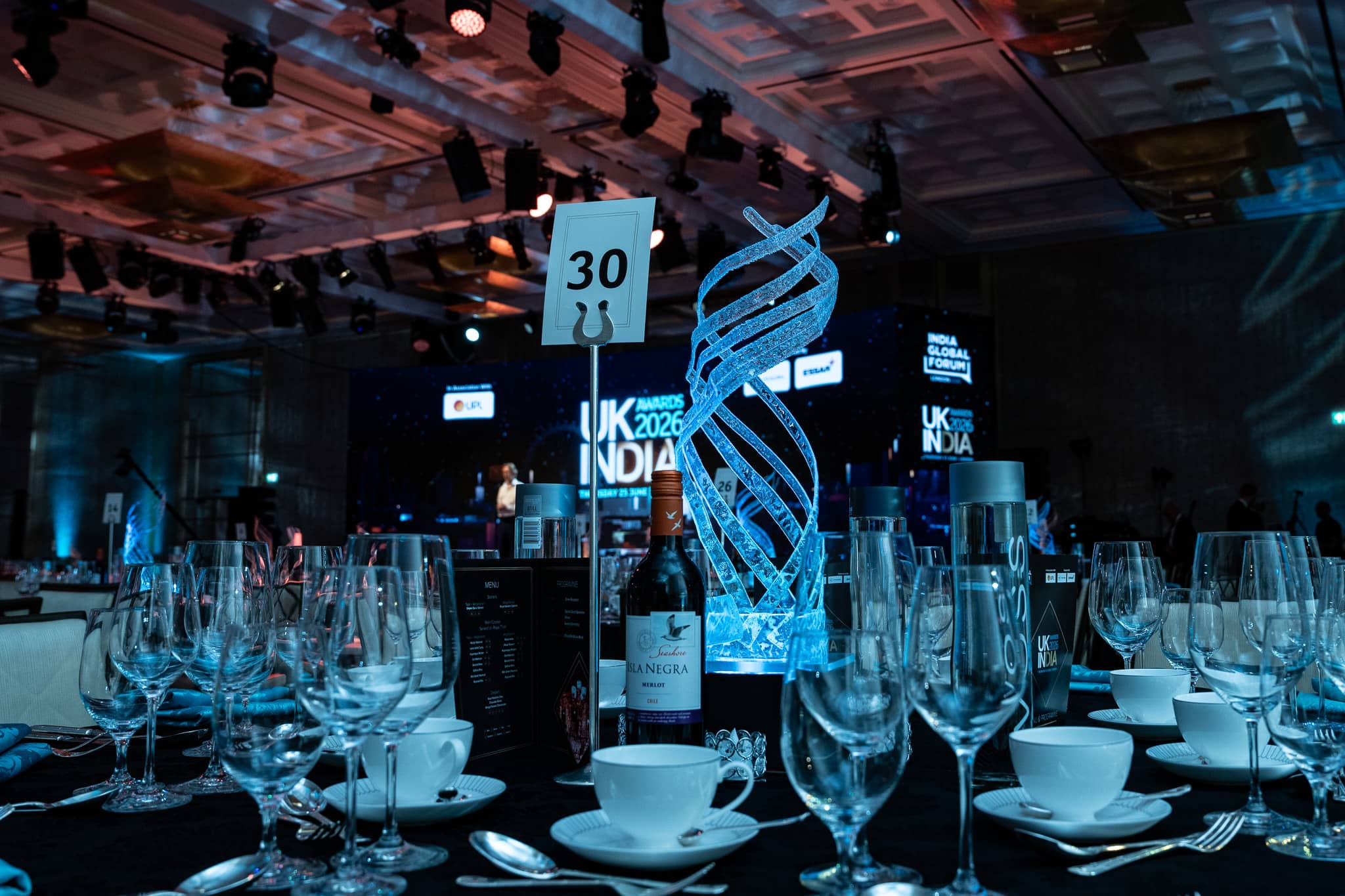 UK-India Awards 2026 at The Peninsula London, table detail with a branded centrepiece, by Kudos AV