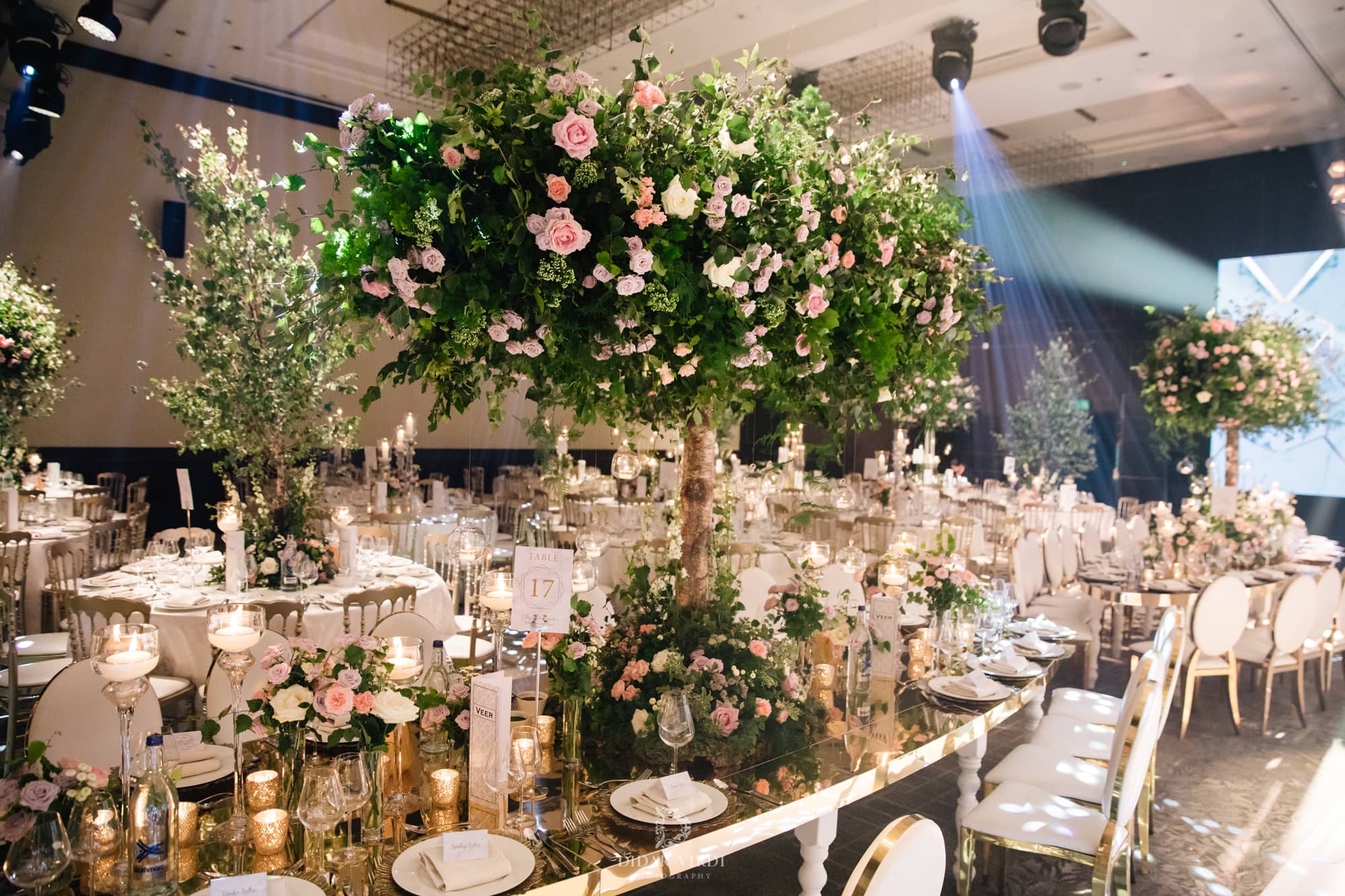 Luxury wedding at Hilton London Bankside, guest tables with floral centrepieces, by Kudos AV