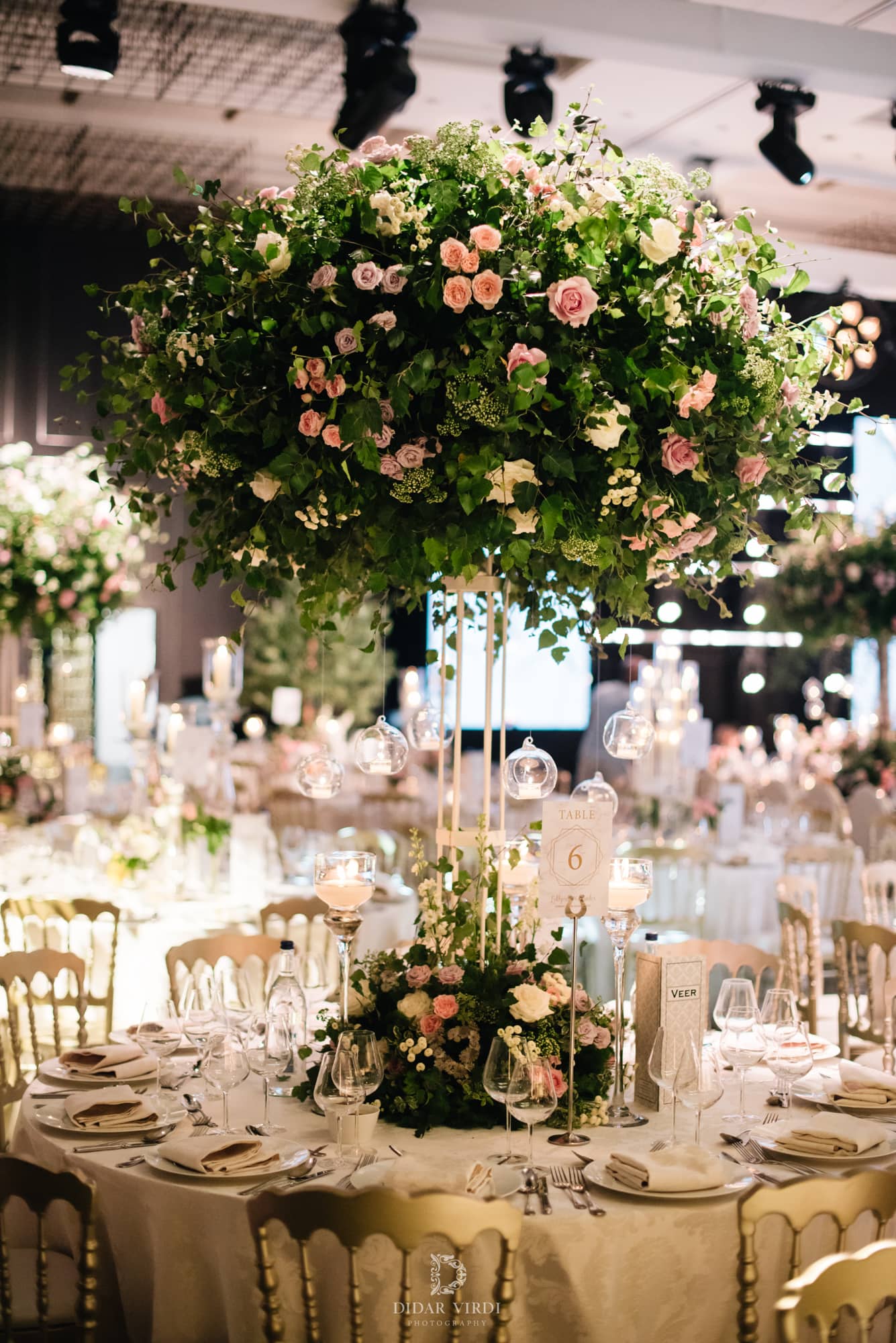 Luxury wedding at Hilton London Bankside, a round guest table with a tall floral centrepiece, by Kudos AV