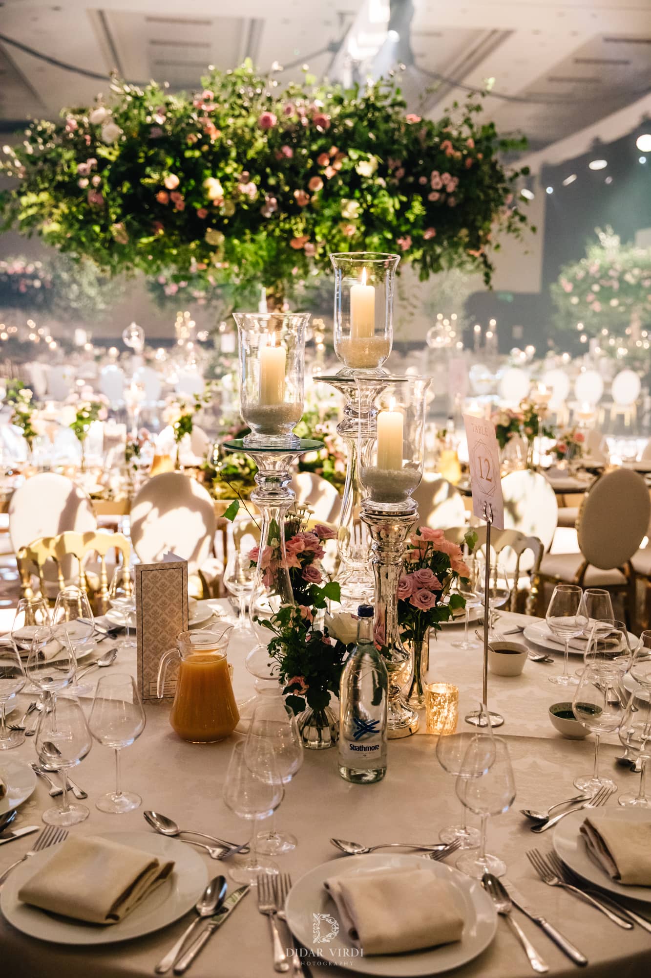 Luxury wedding at Hilton London Bankside, table setting detail with candles and florals, by Kudos AV