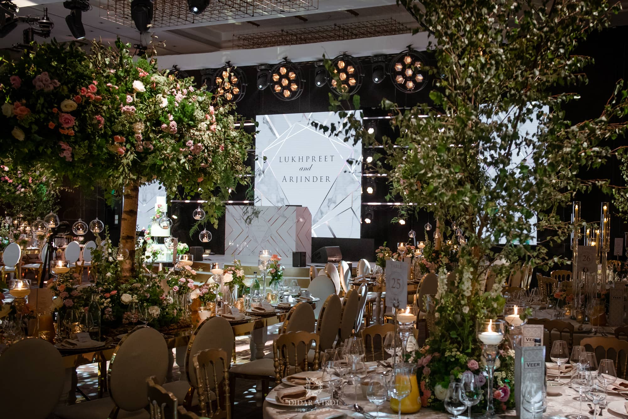 Luxury wedding at Hilton London Bankside, the ballroom with floral tables and LED stage, by Kudos AV