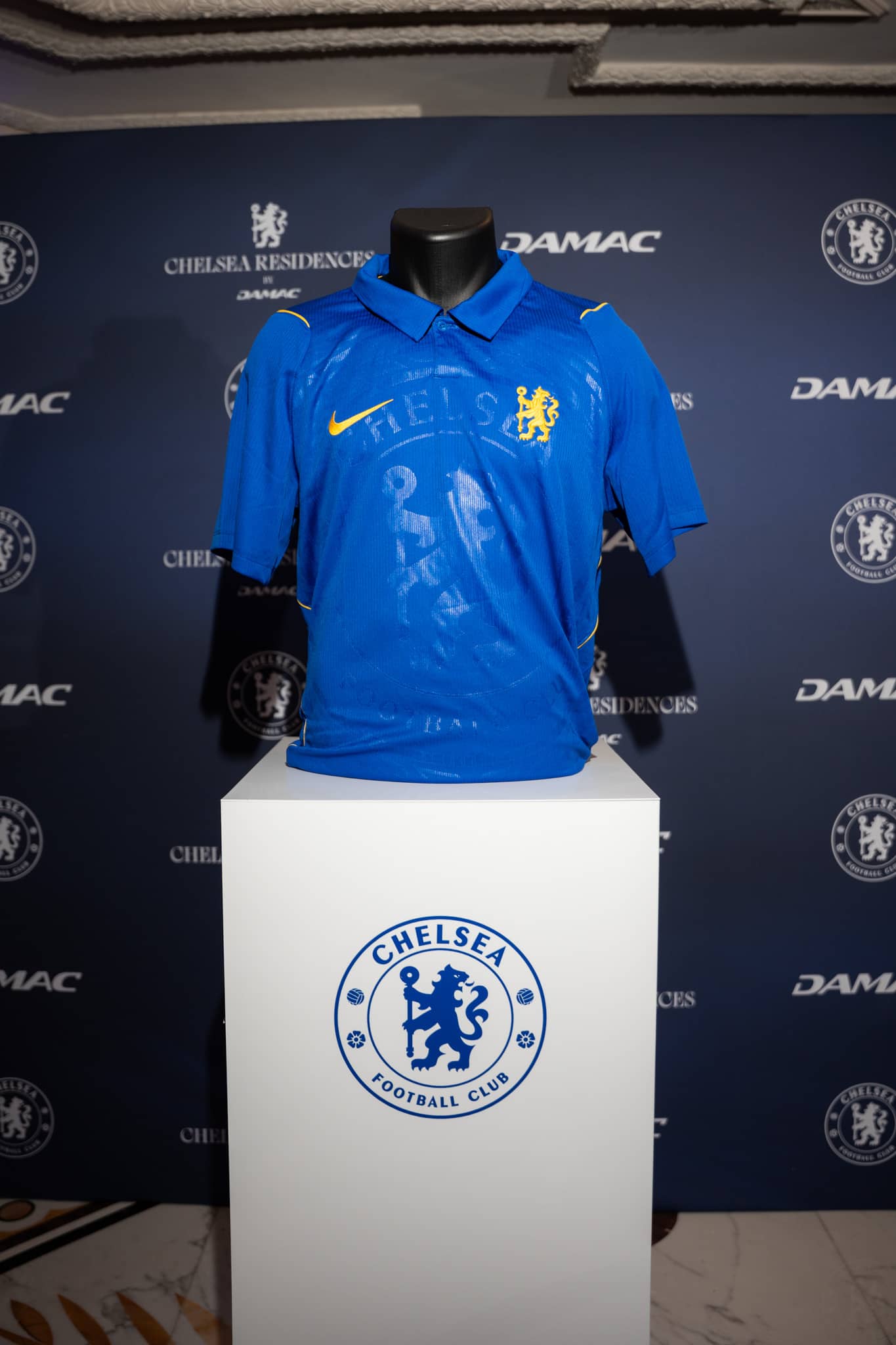 An official Chelsea FC shirt displayed on an illuminated plinth at the London launch
