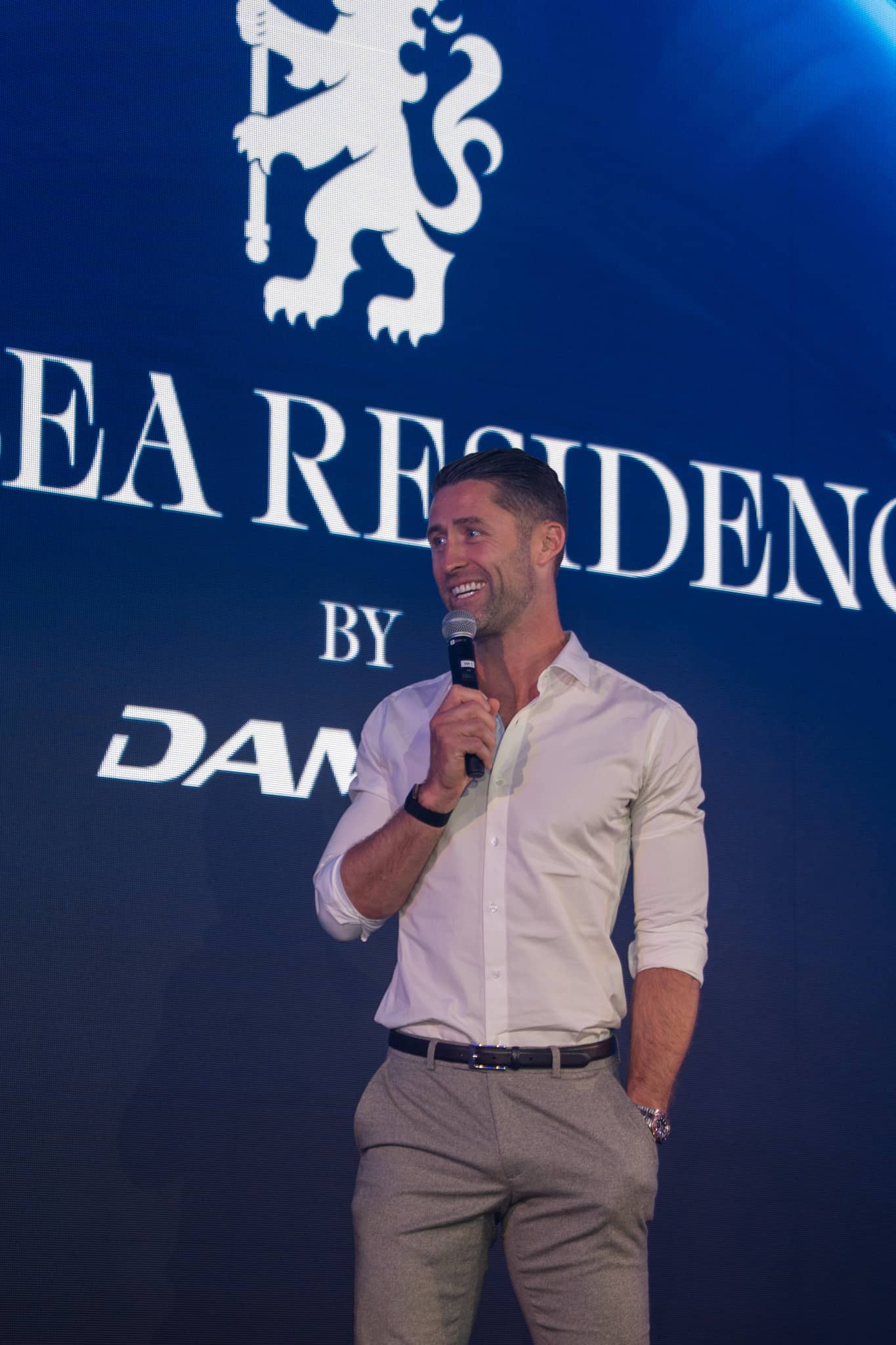 Gary Cahill speaking to guests in front of the Chelsea Residences by DAMAC screen