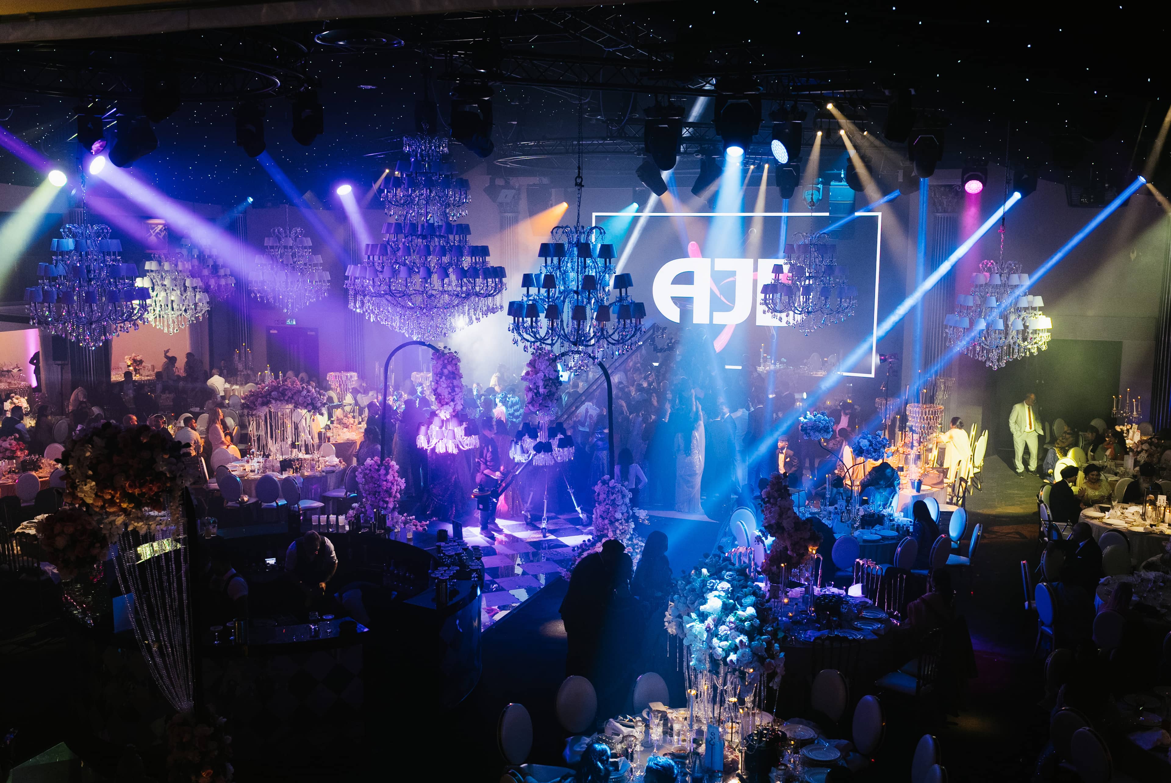 The couple's monogram on the LED screen through beam lighting, by Kudos AV