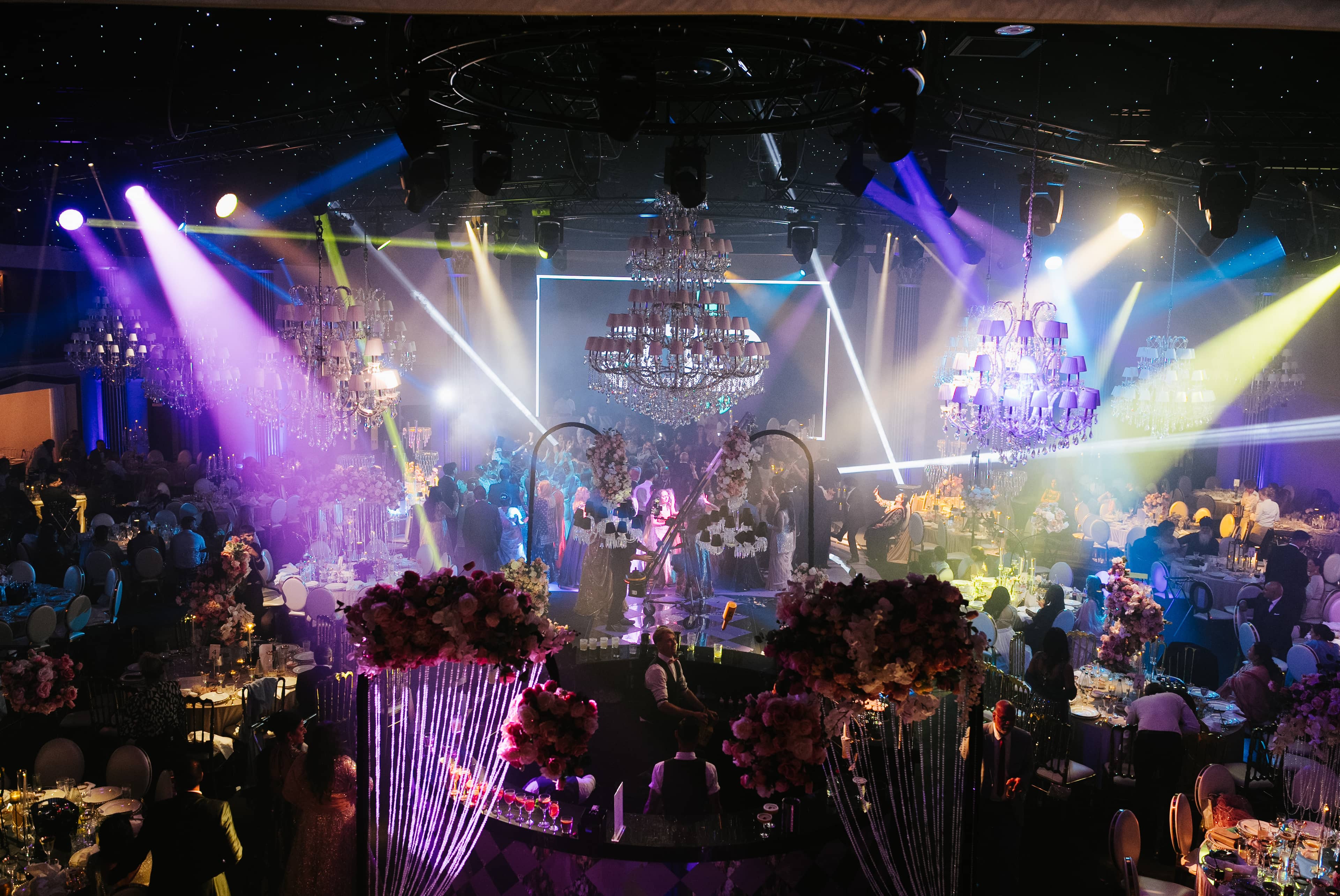 Crystal chandeliers caught in the party light show, by Kudos AV