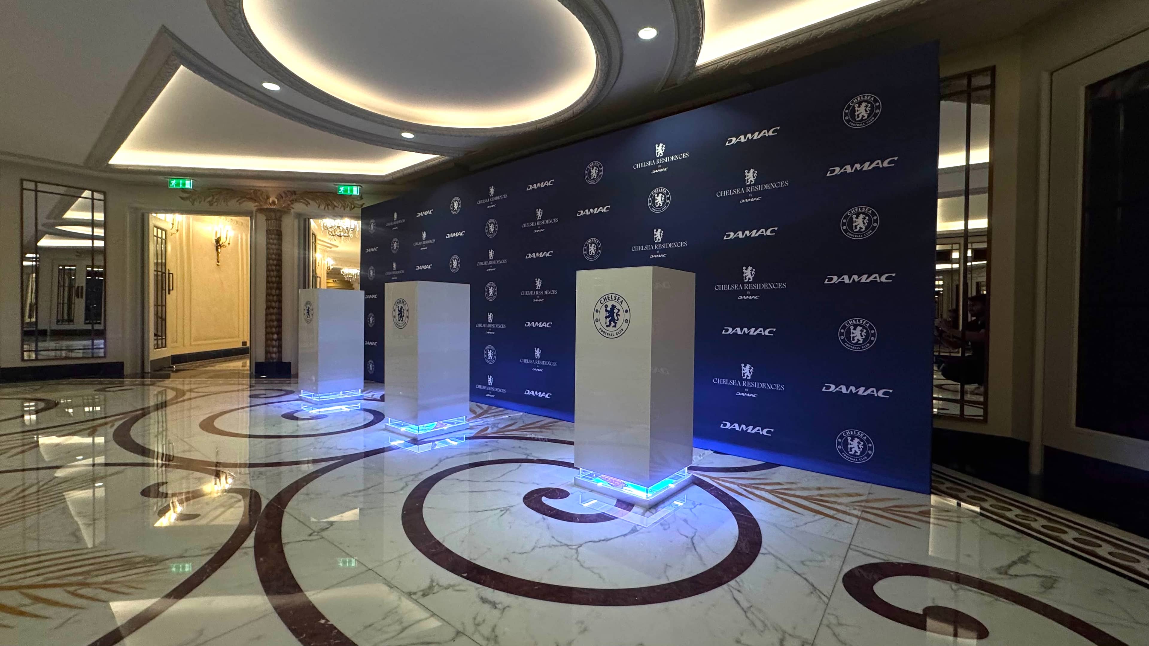 Bespoke branded event plinths and printed media wall for Chelsea Residences by DAMAC, produced and installed by Kudos AV