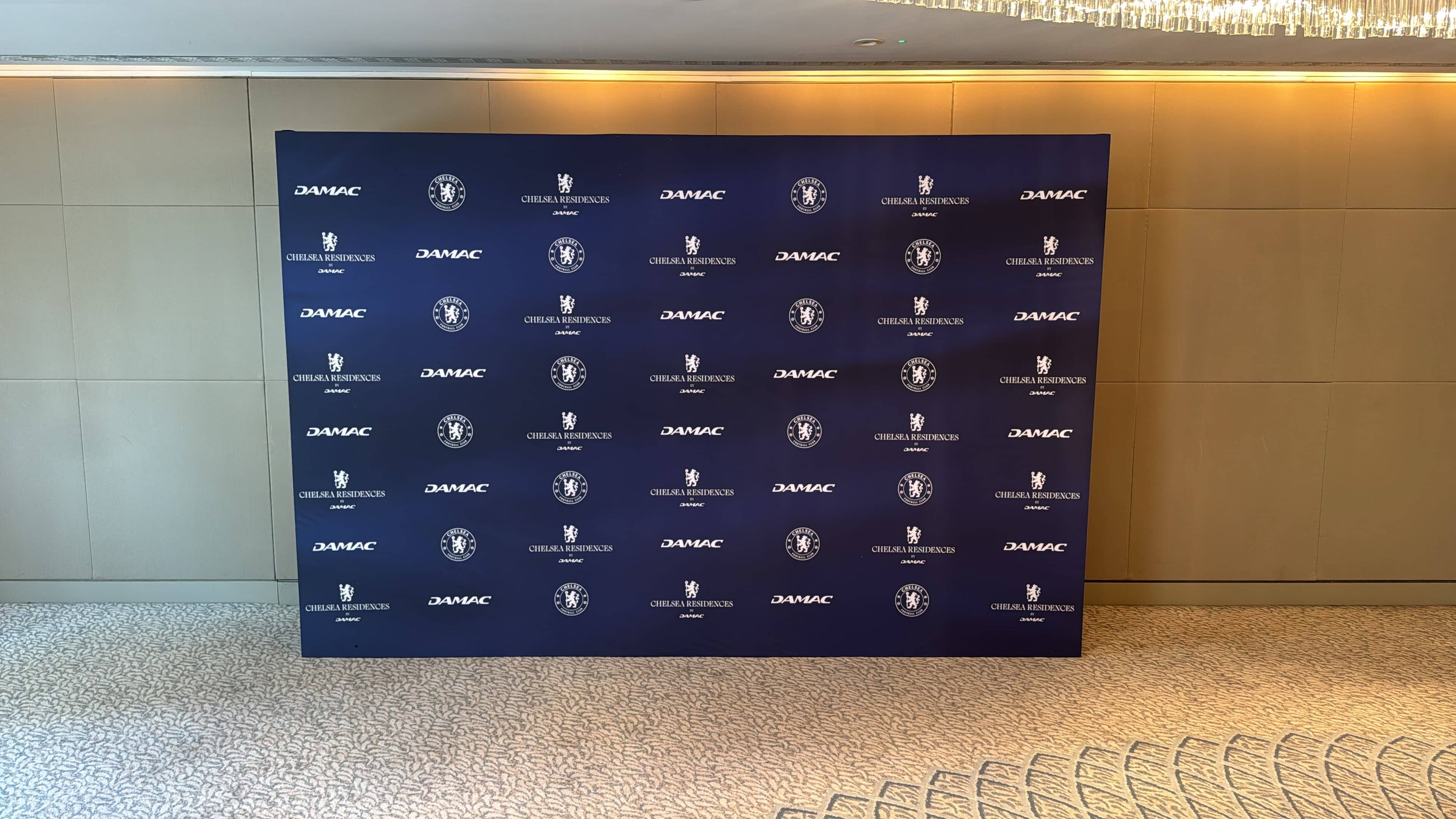 Large format printed step and repeat backdrop for Chelsea Residences by DAMAC, printed by Kudos AV