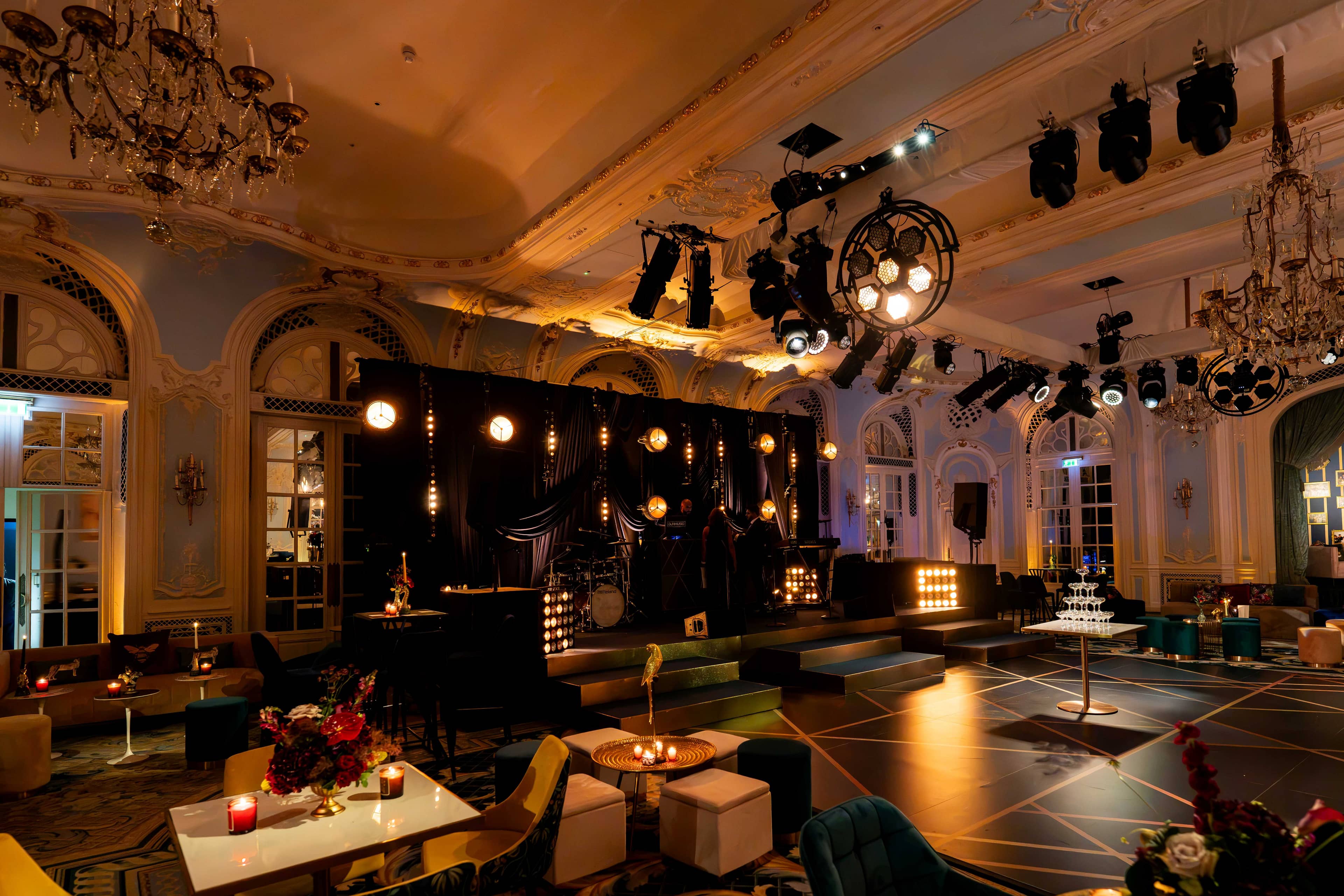 The Savoy wedding room set for the evening, dancefloor taped in gold and the stage glowing, by Kudos AV