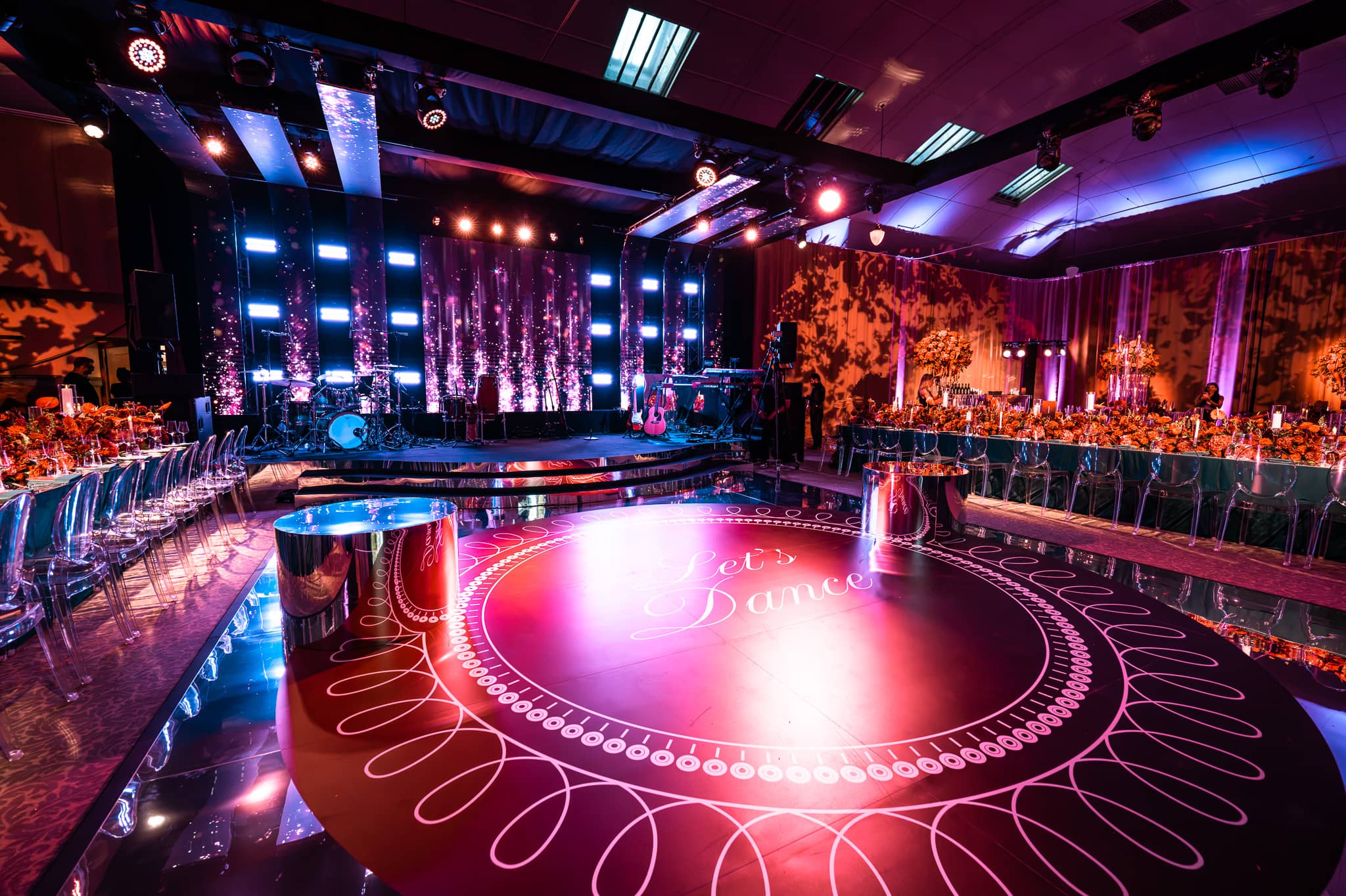 Tatton Park wedding in the Tenants' Hall, guest tables around the lit dancefloor, produced by Kudos AV