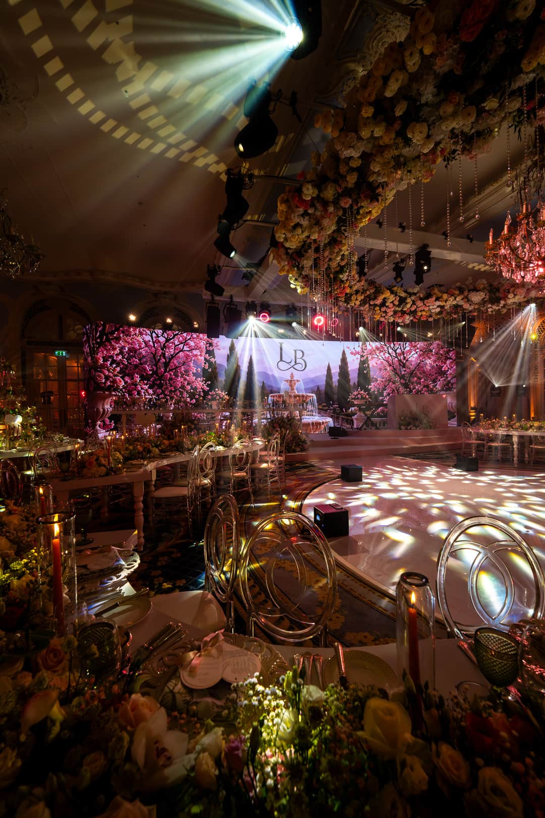 A curved LED screen carrying a blossom garden behind the stage in the Lancaster Ballroom at The Savoy, by Kudos AV