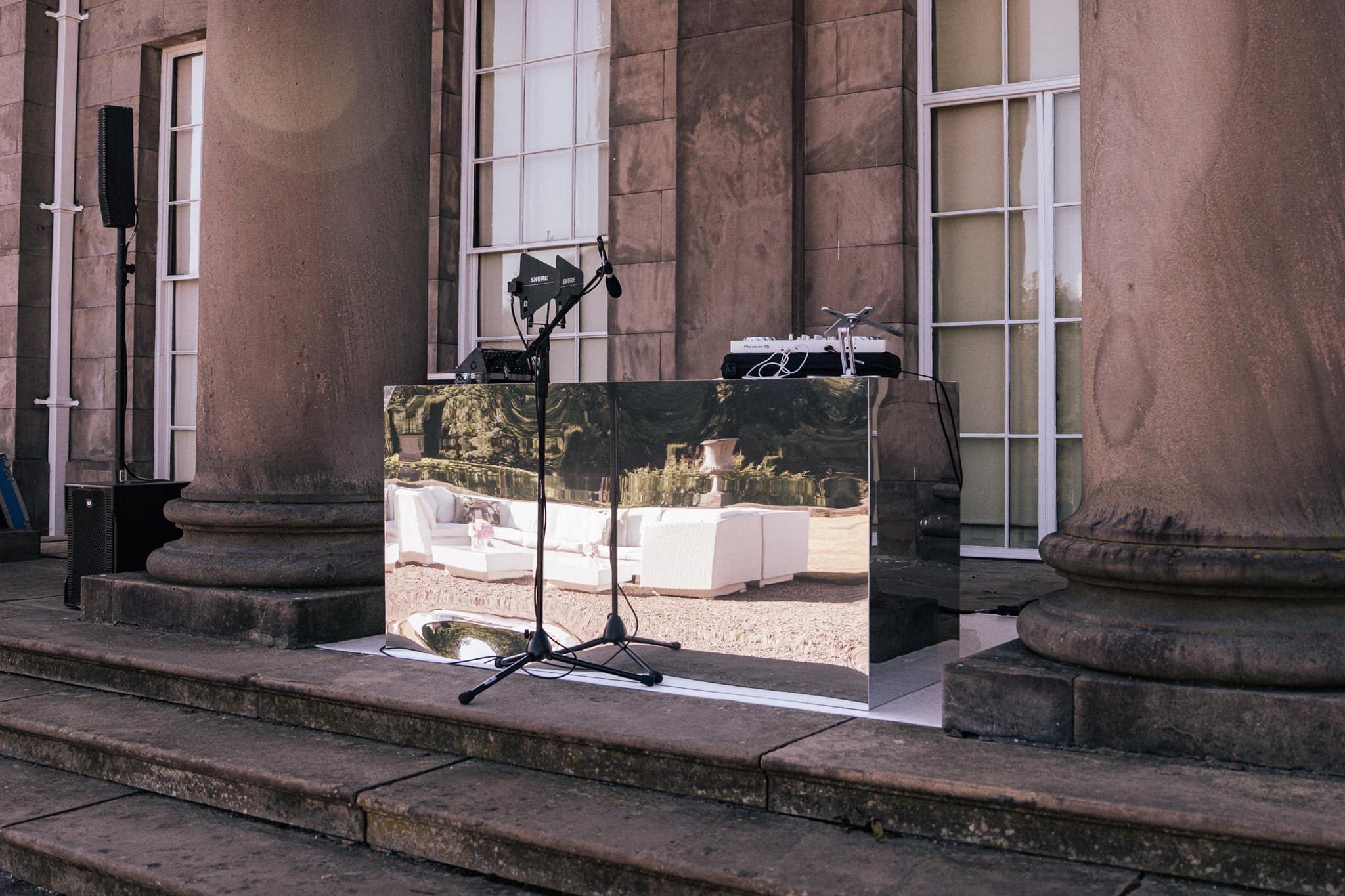 A mirror-finish LED screen set outdoors against the stone of Tatton Park mansion by Kudos AV