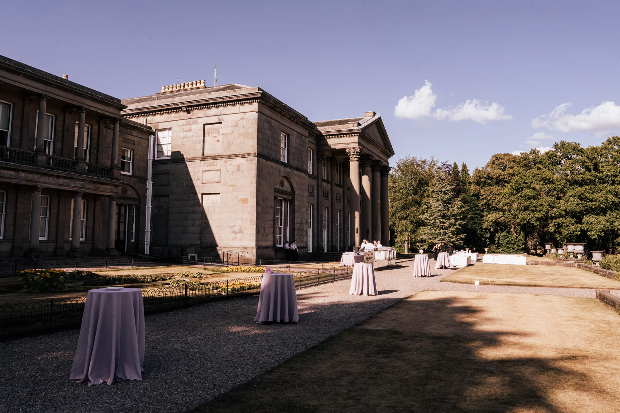 Tatton Park mansion with draped cocktail tables set for a wedding drinks reception, produced by Kudos AV