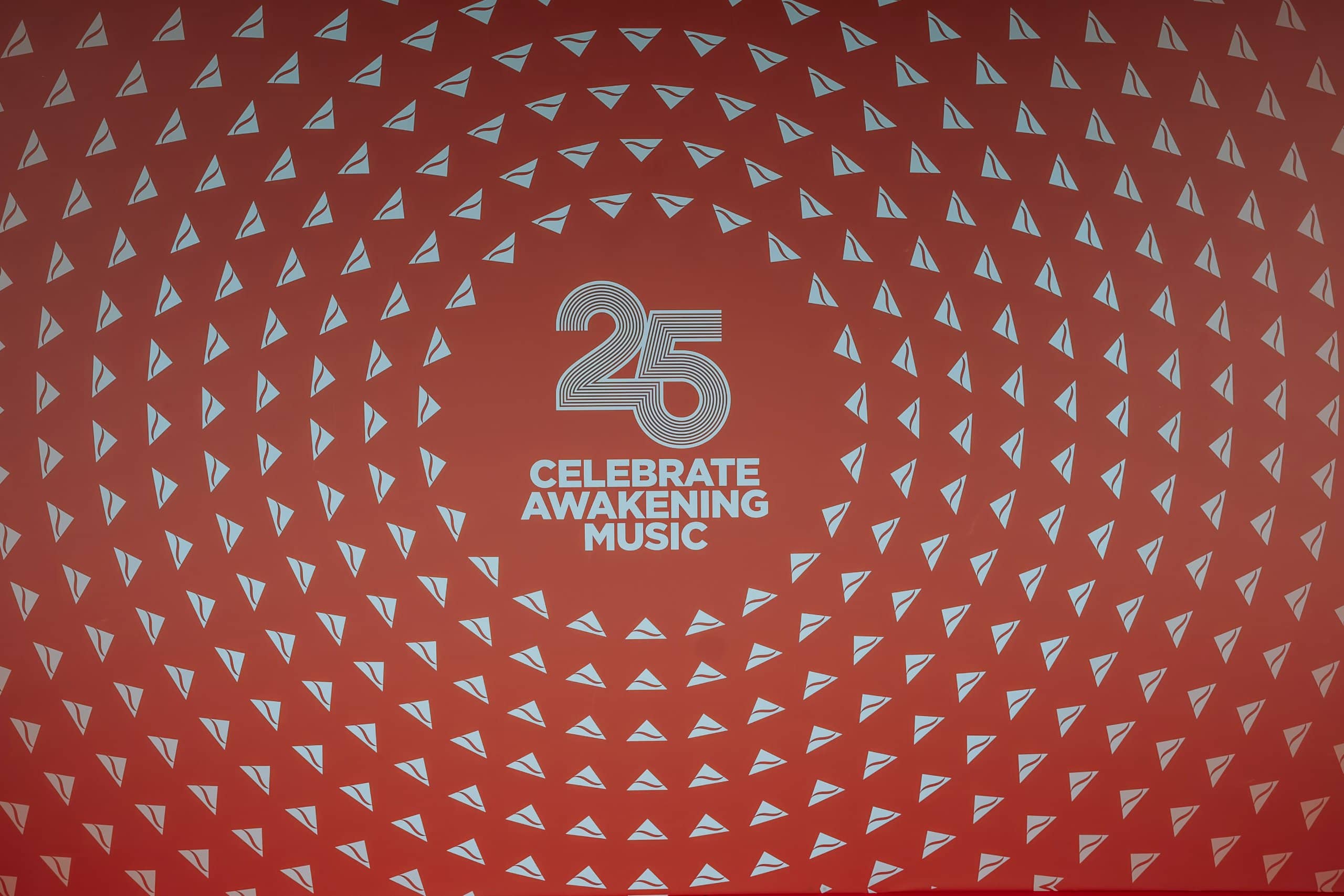 The printed backdrop for the Awakening Music 25th anniversary: the 25 mark on red with a radiating triangle pattern, printed by Kudos AV for the celebration at the Natural History Museum.