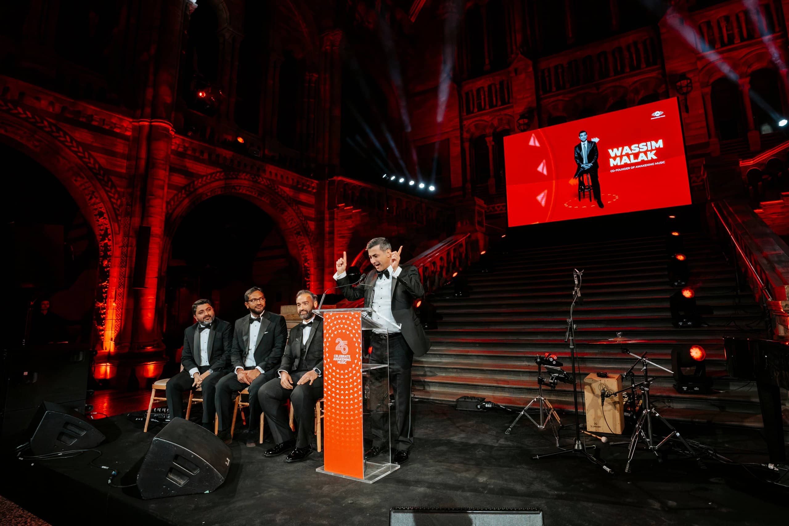 The panel on stage and the speaker at the lectern in front of the 6m x 4m Unilumin P2.6 LED screen, Awakening Music 25th anniversary by Kudos AV.
