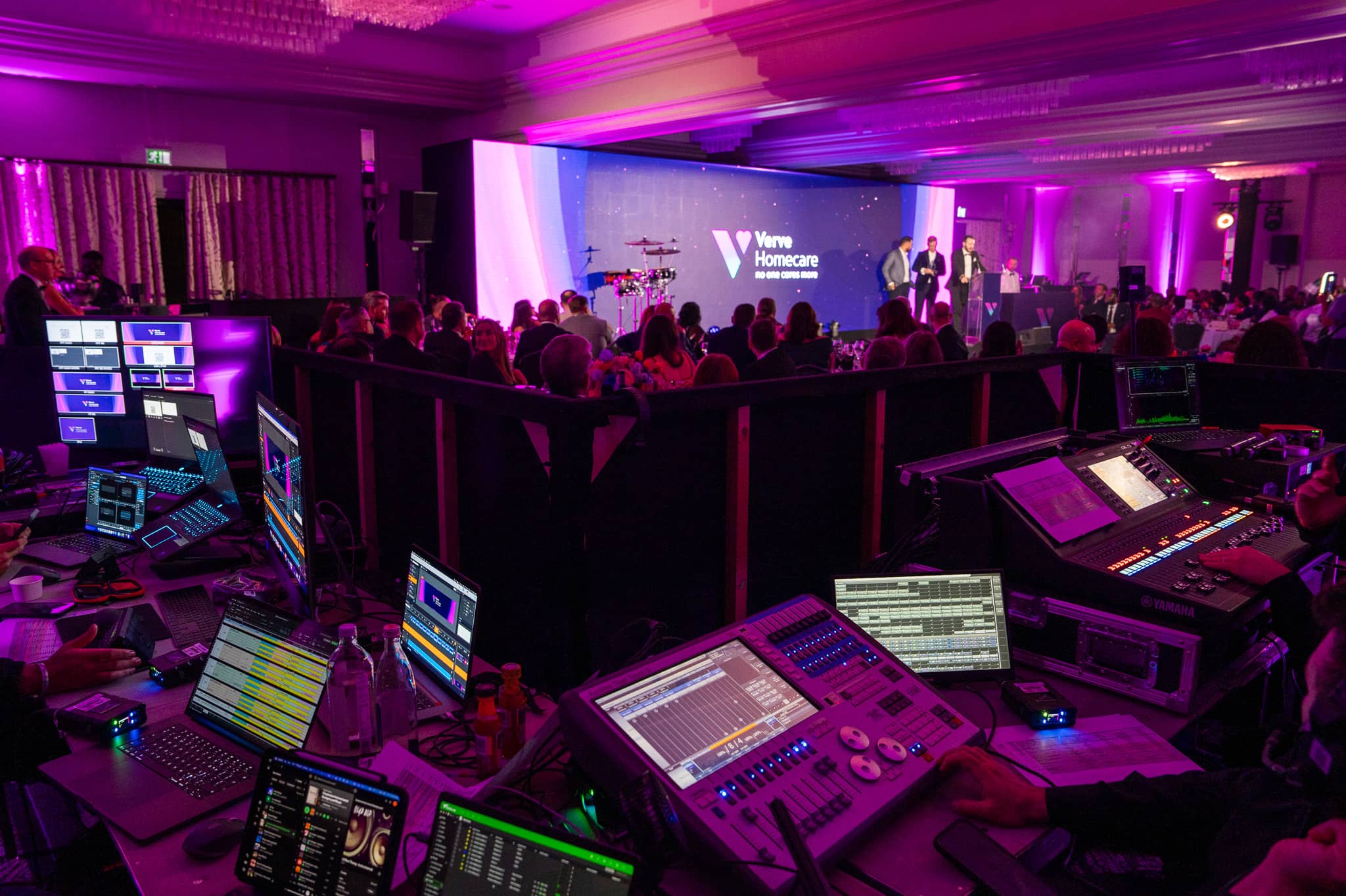 The Kudos AV front of house control position at Verve Awards Night, with lighting, sound and video desks looking over the stage in the St Alban Suite.