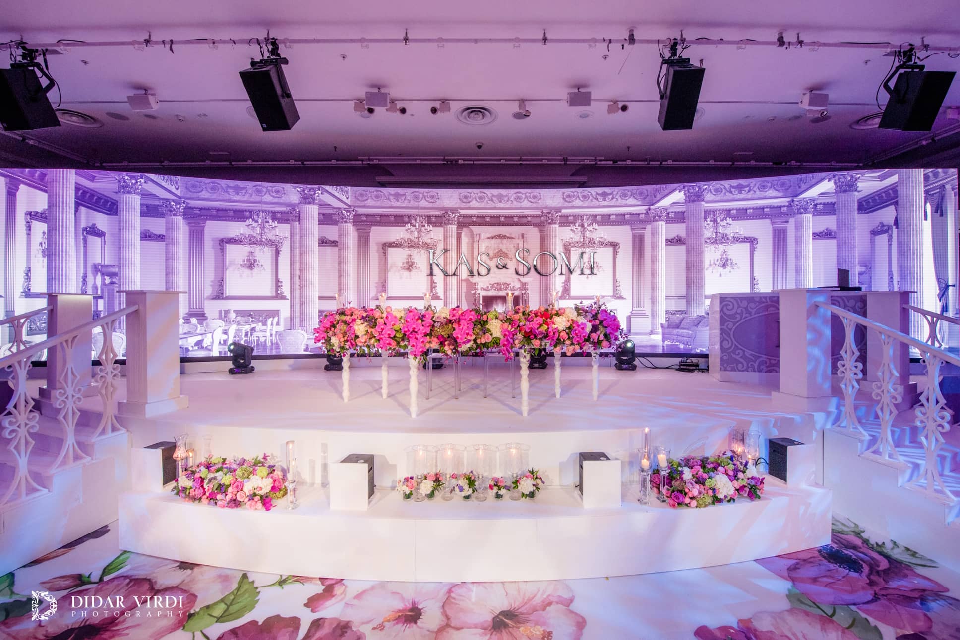 Curved Unilumin P2.6 LED screen showing palazzo-style architecture behind a white stage with tiers and decorative balustrades at Grosvenor House.