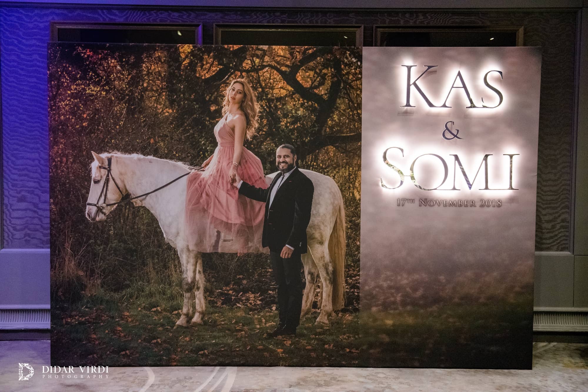 Printed photographic media wall with illuminated lettering and LED strip lighting in the Grosvenor House wedding foyer.