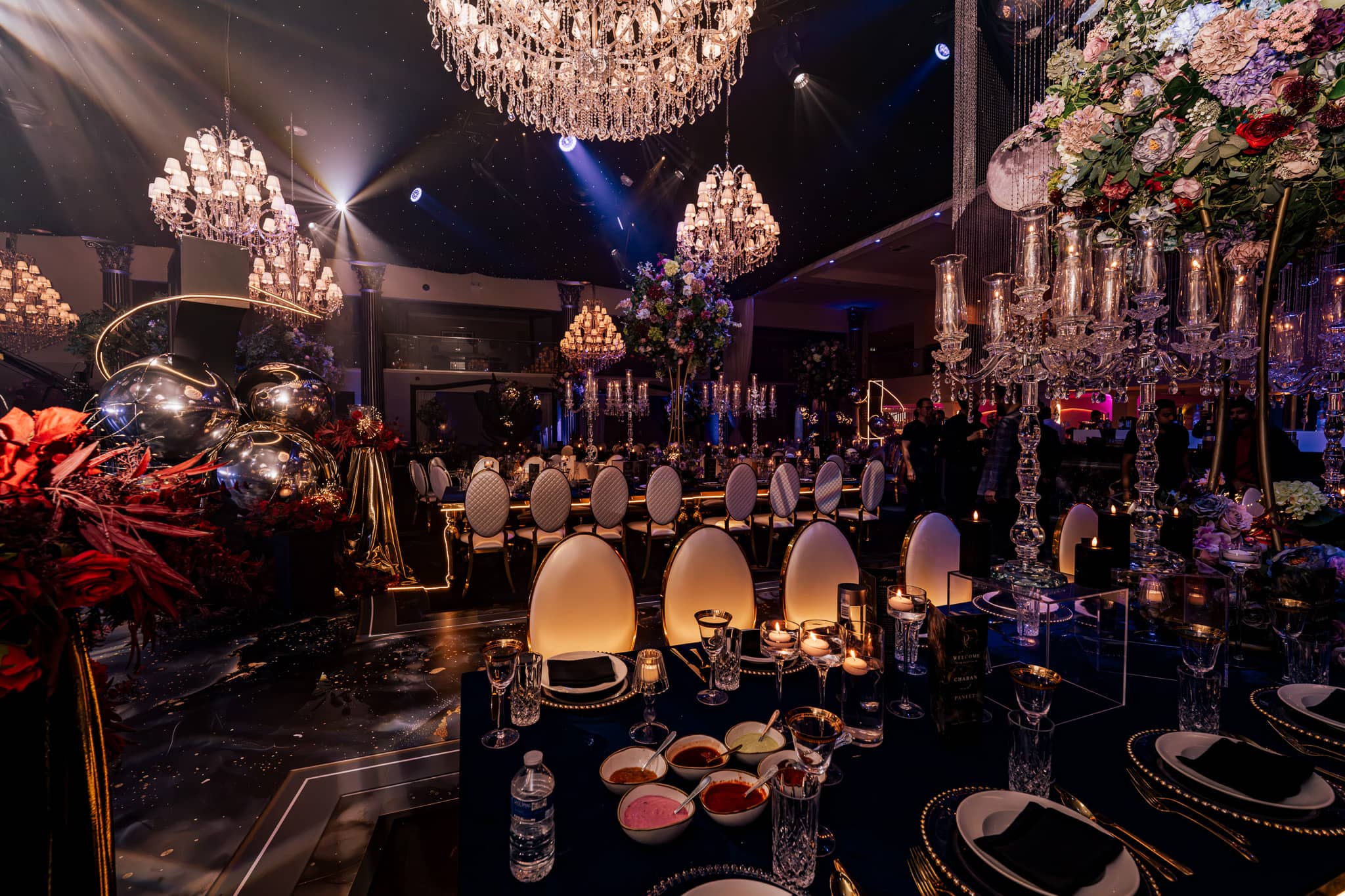 Floral installations and chandeliers over the tables, by Kudos AV