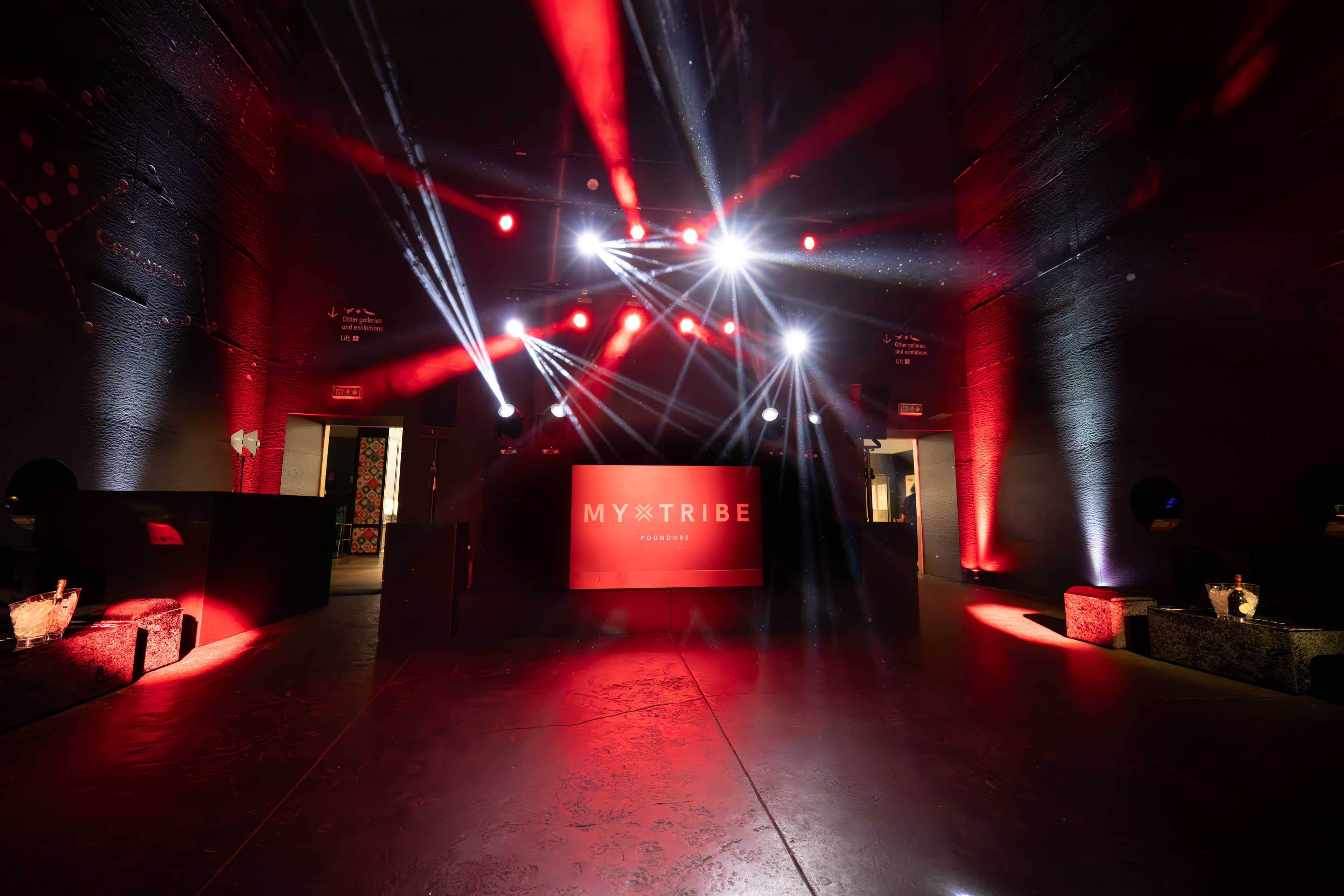 Moving lights over the stage and dancefloor, red uplighting on the columns of Earth Hall, FOUNDXRS Club black tie party by Kudos AV.