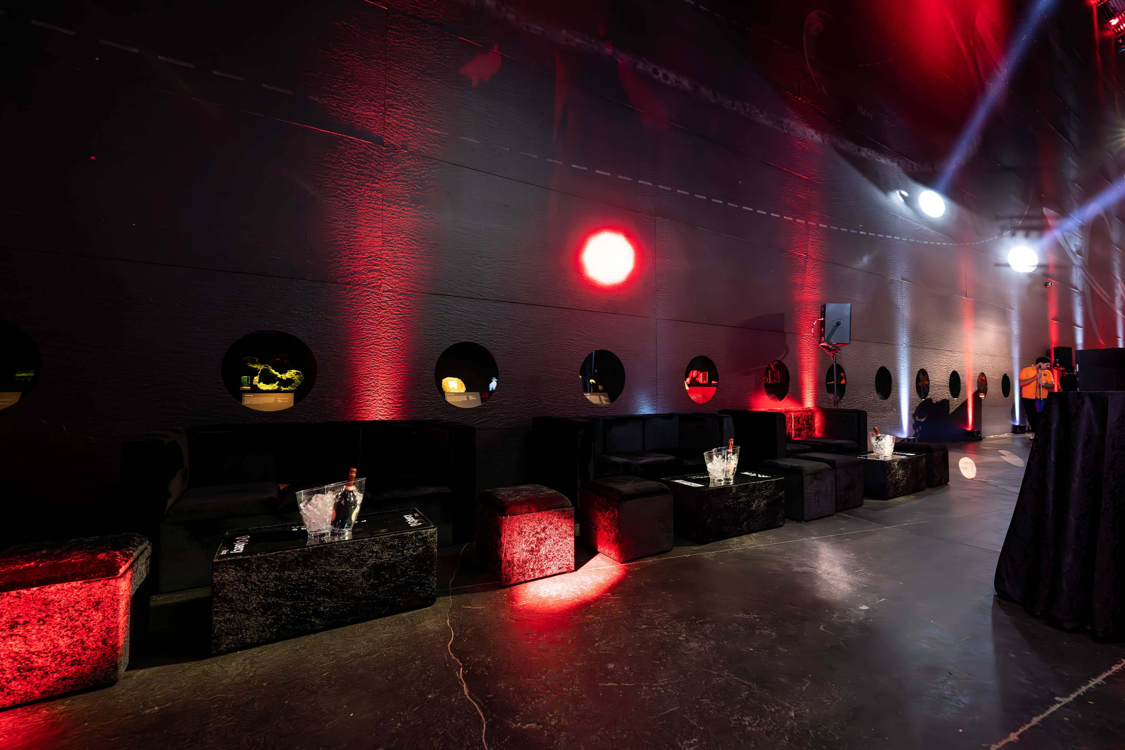 The lounge for the FOUNDXRS Club black tie party: lit seating and red uplighting on the walls of Earth Hall, by Kudos AV.