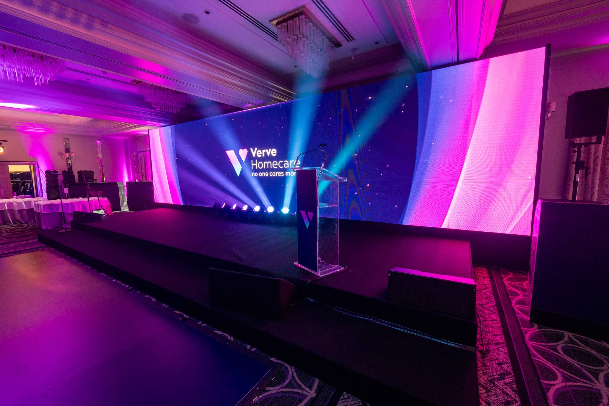The Verve Awards Night stage at Sopwell House with a branded acrylic lectern, 10m LED wall and pink uplighting in the St Alban Suite.