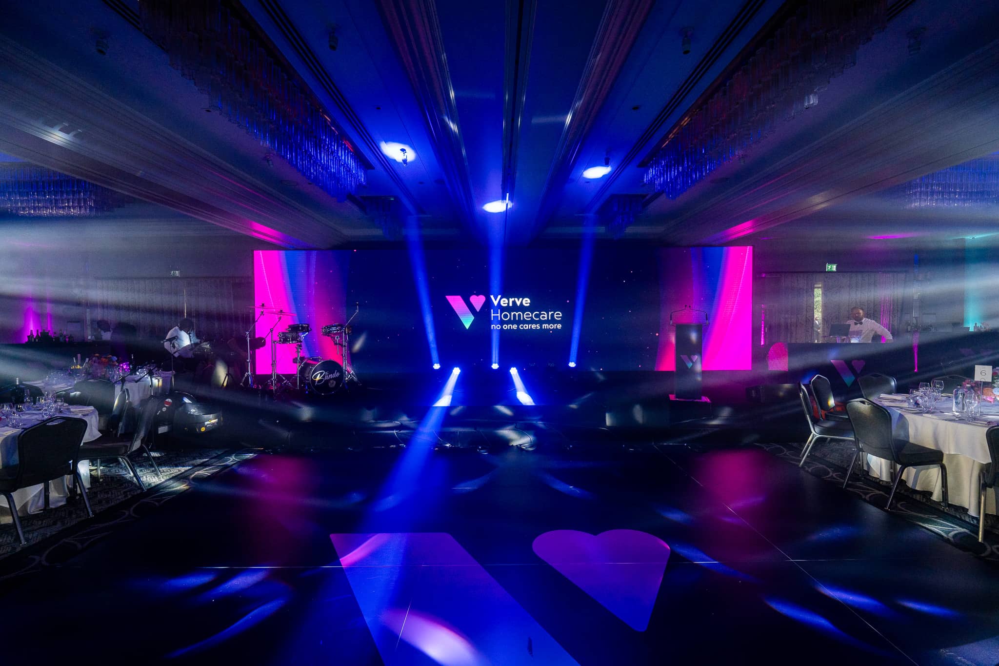 Blue moving head beams fan across the St Alban Suite towards the Verve Homecare LED wall and awards stage at Sopwell House.