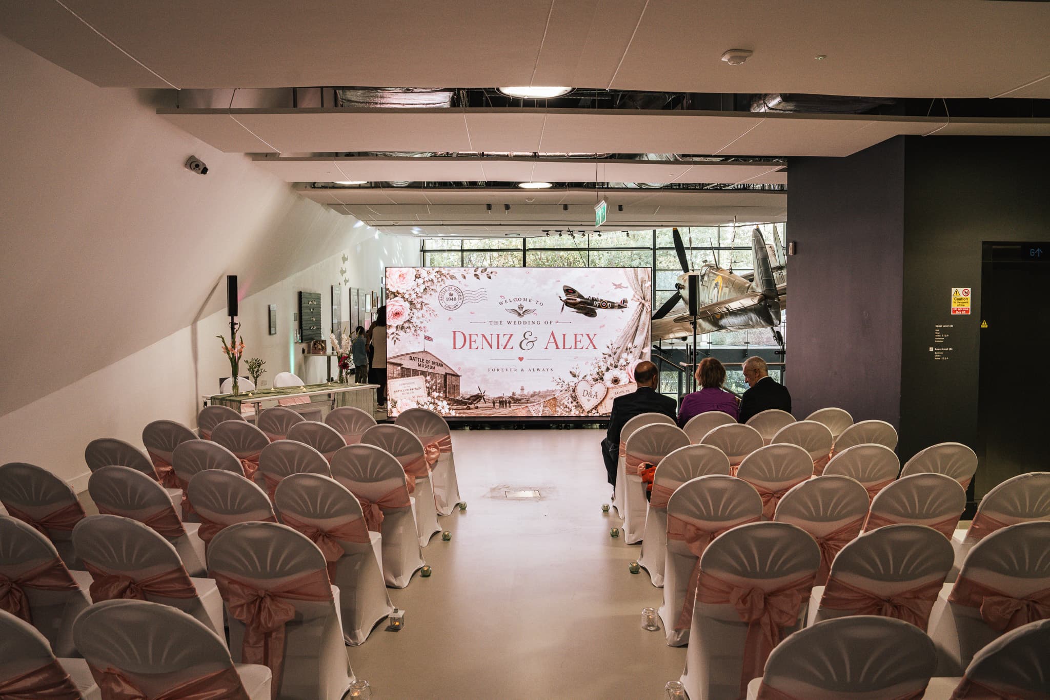 Wedding ceremony seating facing a six-panel LED totem wall, hired from Kudos AV