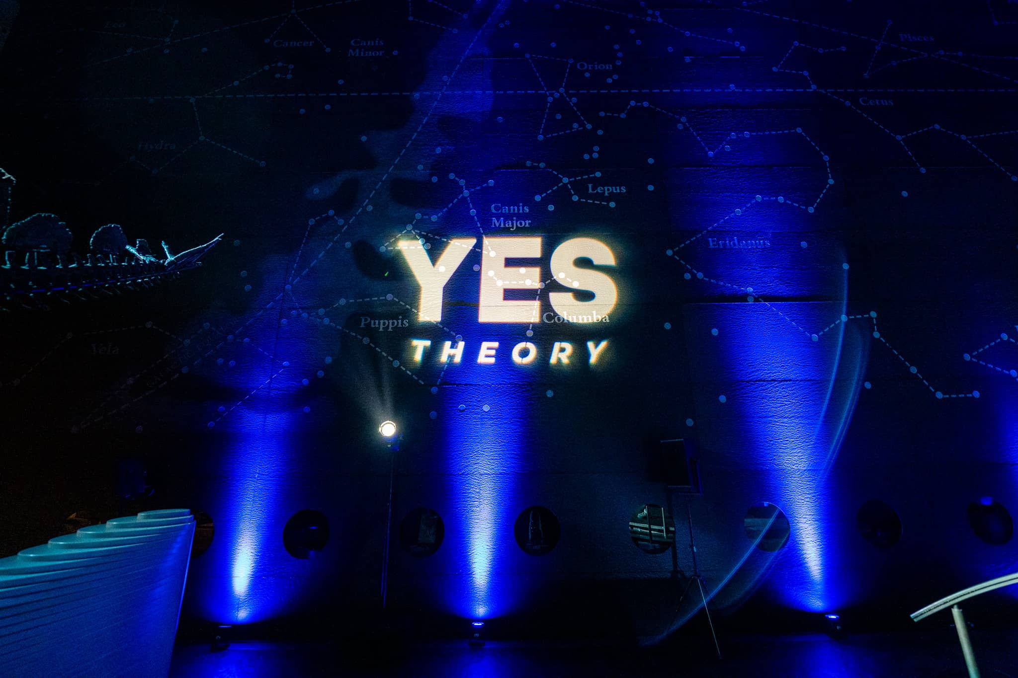 The Yes Theory name lit in Earth Hall with constellation patterns and blue uplighting for the Yes Theory 10 million subscriber celebration, by Kudos AV.