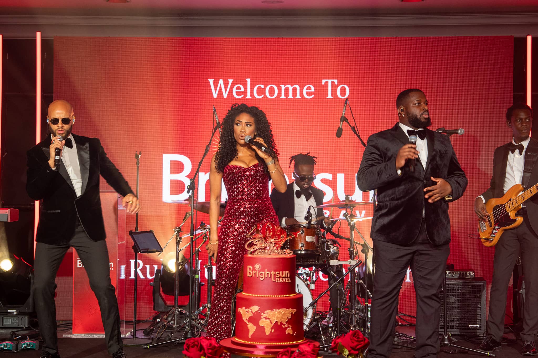 Goldn Global’s singers performing in front of the Brightsun anniversary stage backdrop, at Brightsun Travel’s 40th anniversary at InterContinental London Park Lane.