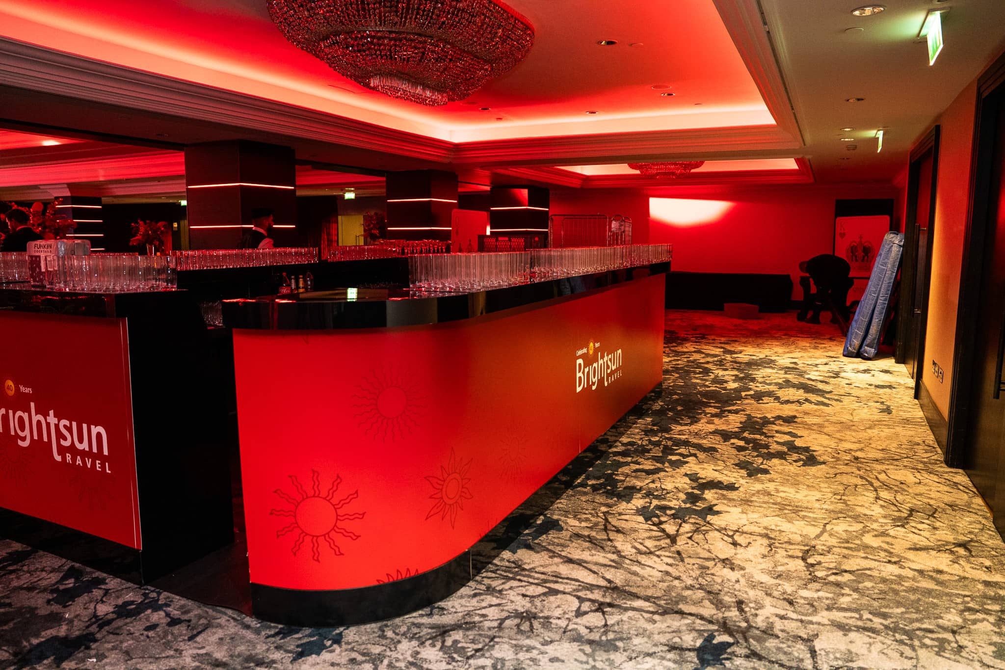 The printed Brightsun bar in the red-lit reception area, at Brightsun Travel’s 40th anniversary at InterContinental London Park Lane.