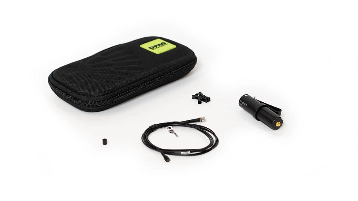 Black DPA 4060 CORE+ lavalier microphone kit with microphone and cable, clothing clip, XLR adaptor and DPA storage pouch on a white background.