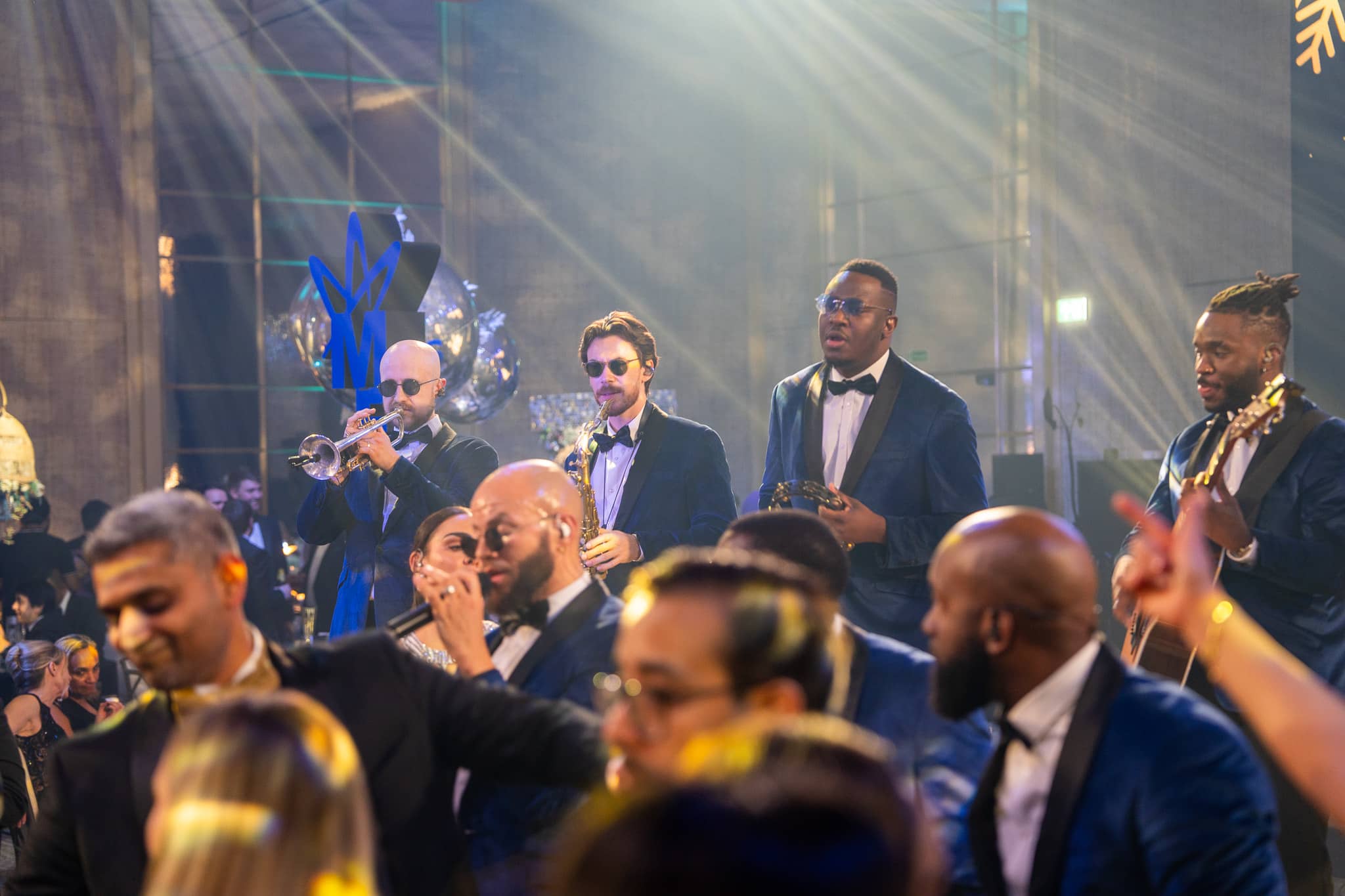 The Function Band vocalists perform among the guests with microphones at the MFS Christmas party