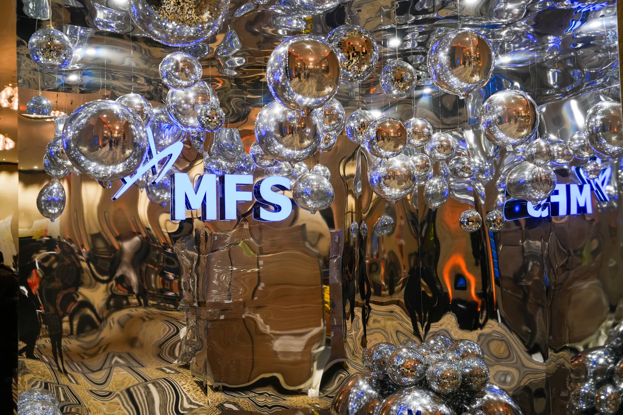 MFS lettering among mirrored spheres and a reflective backdrop at The Peninsula London Christmas party