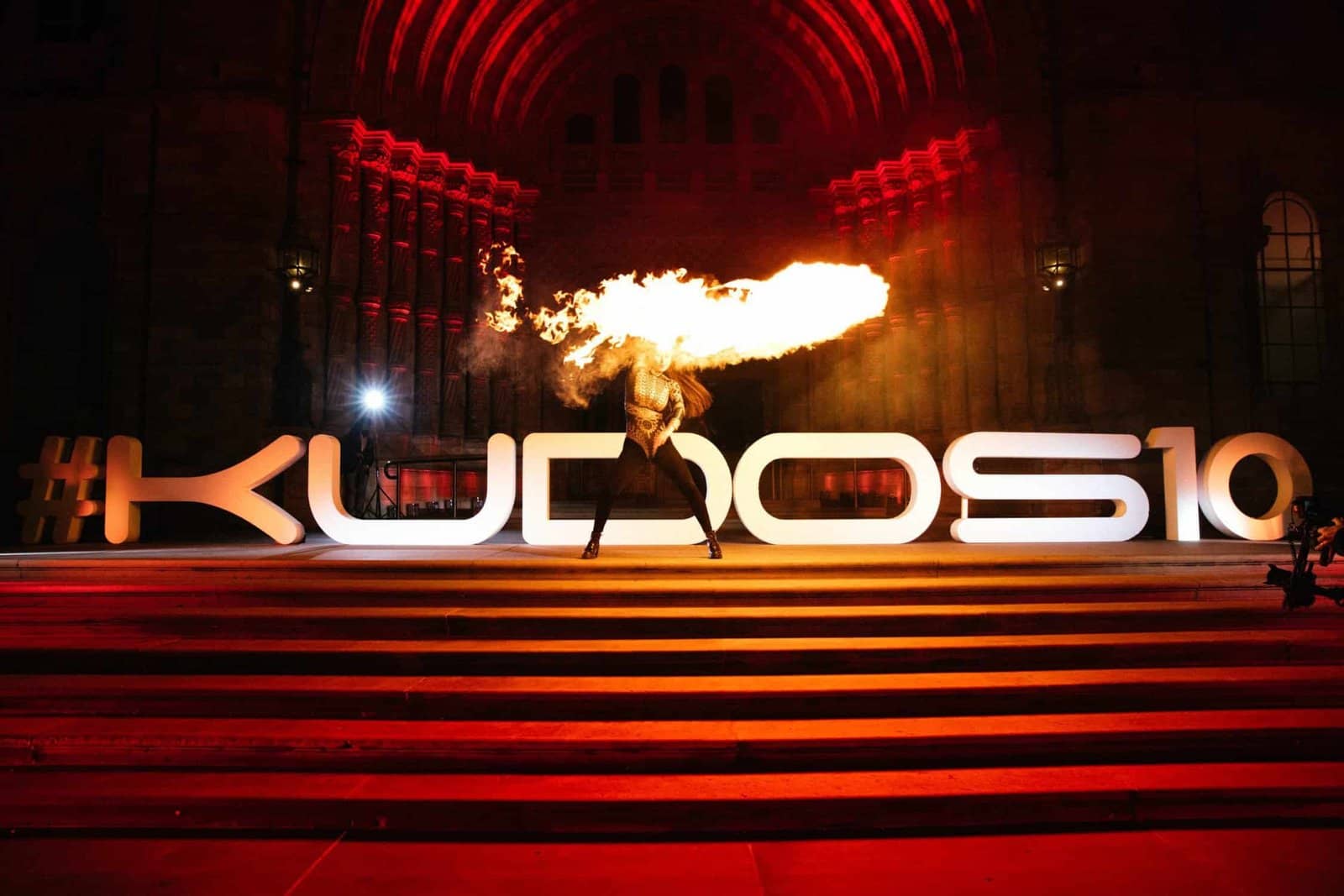 Kudos 10 at the Natural History Museum, 3D #KUDOS10 lettering with a flame effect on the illuminated staircase, by Kudos AV
