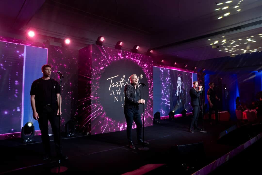 A full width LED backdrop and side screens at an awards ceremony produced by Kudos AV