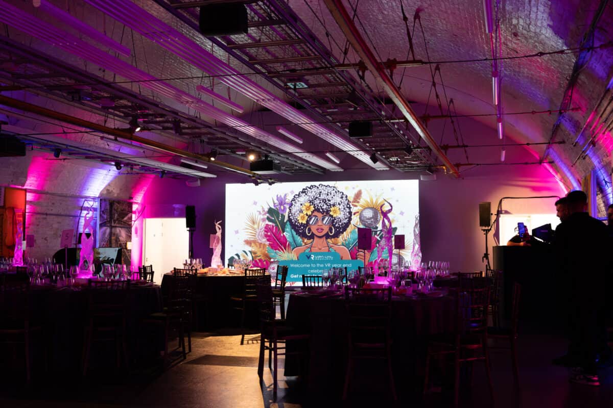 Gala dinner set beneath the brick arches of the Mail Rail tunnel with an LED wall, produced by Kudos AV