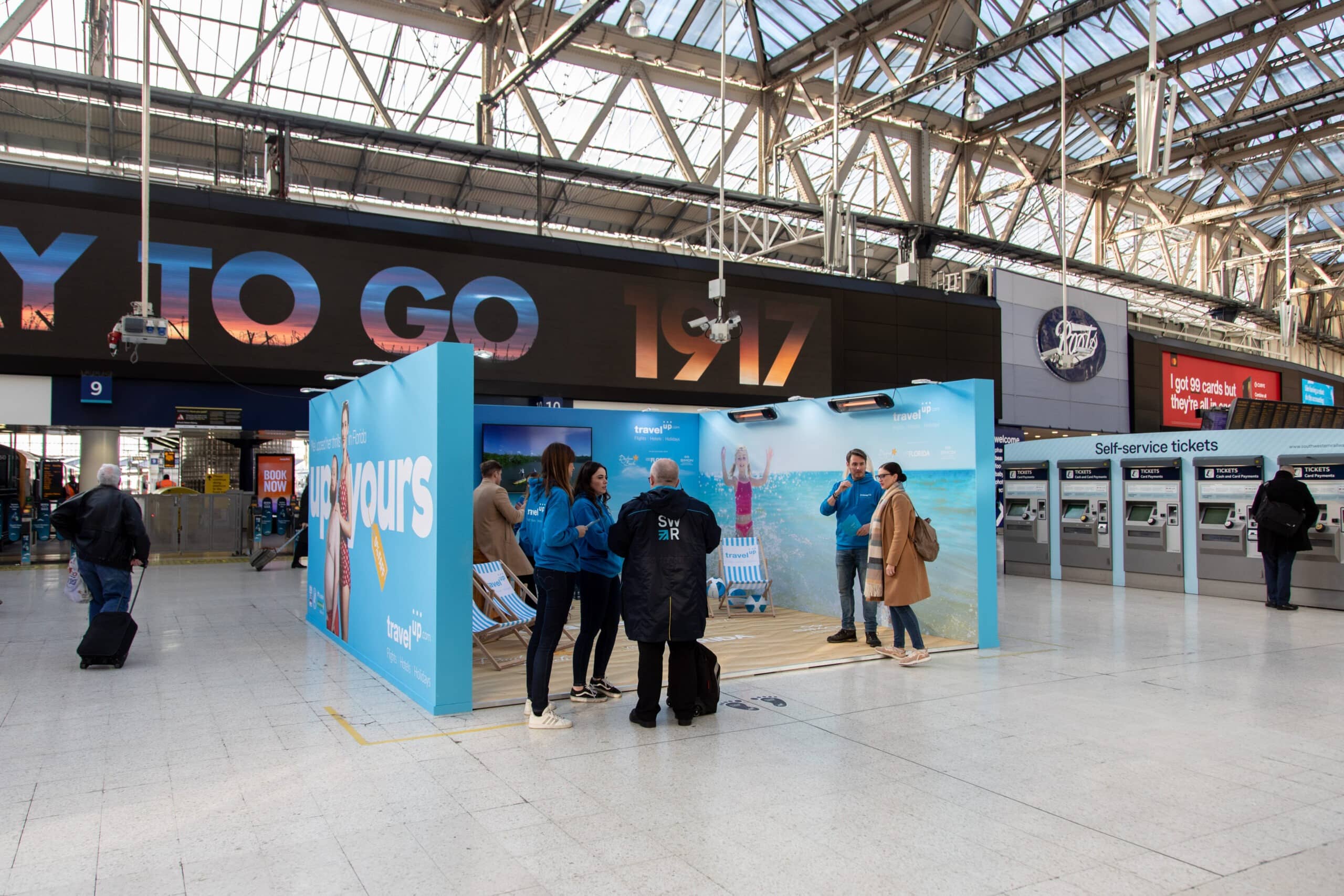 Printed pop up brand activation stand at a London station by Kudos AV