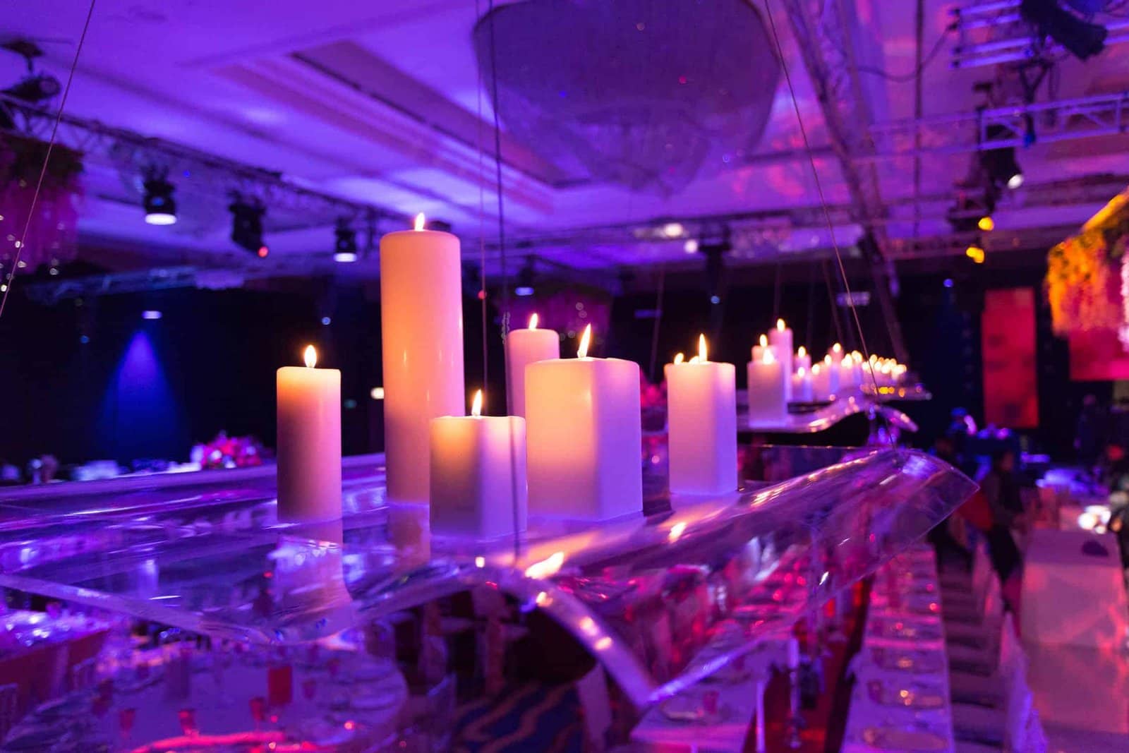 Wedding at the London Hilton on Park Lane, candlelit table detail under purple lighting, by Kudos AV